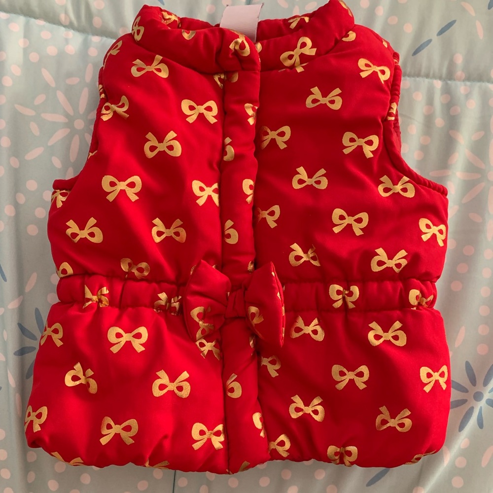 Red puffer vest with bows